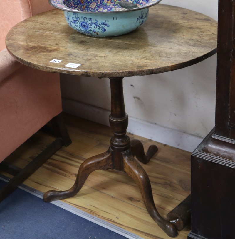 A George III oak and mahogany tilt top tripod tea table, diameter 76cm
